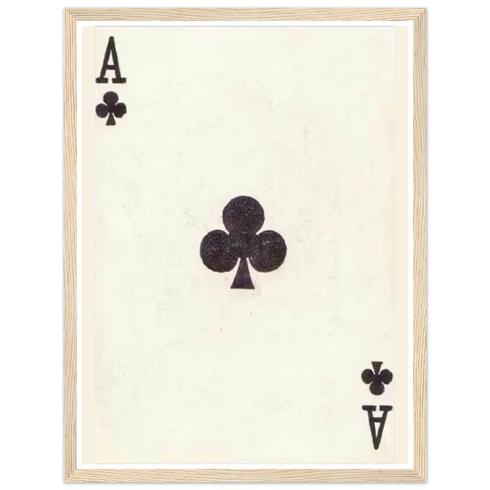 Black ace of clubs playing card on an aged cream background in a natural wood frame.