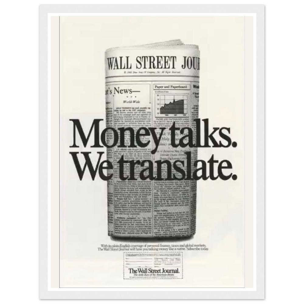 Money talks. We translate. lettering over a rolled financial newspaper in a white frame.