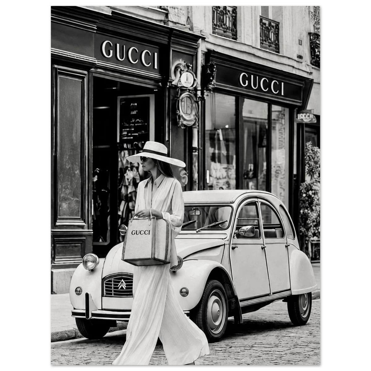 Woman in a sunhat walking past a vintage car outside a boutique in black and white as an unframed poster.