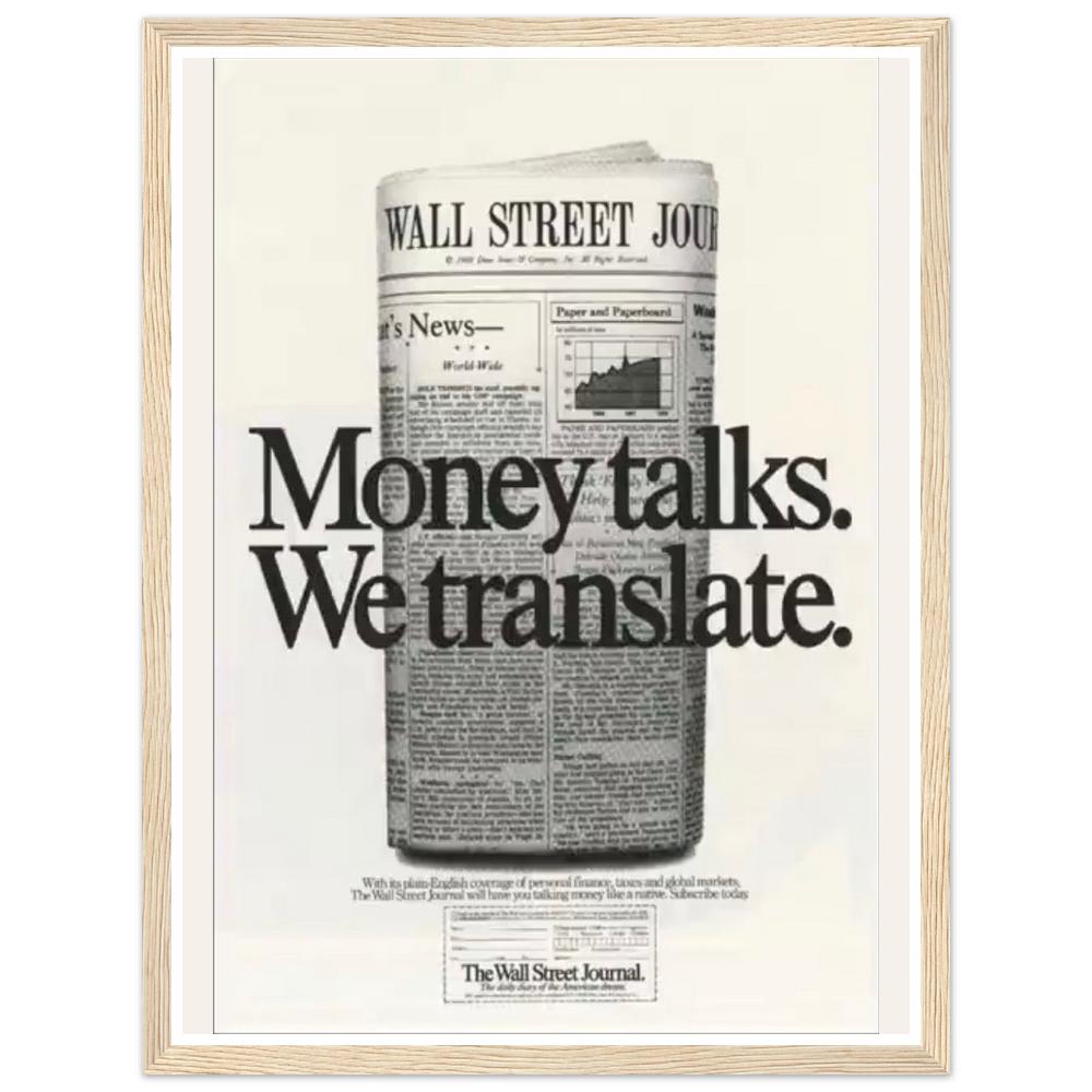 Money talks. We translate. lettering over a rolled financial newspaper in a natural wood frame.