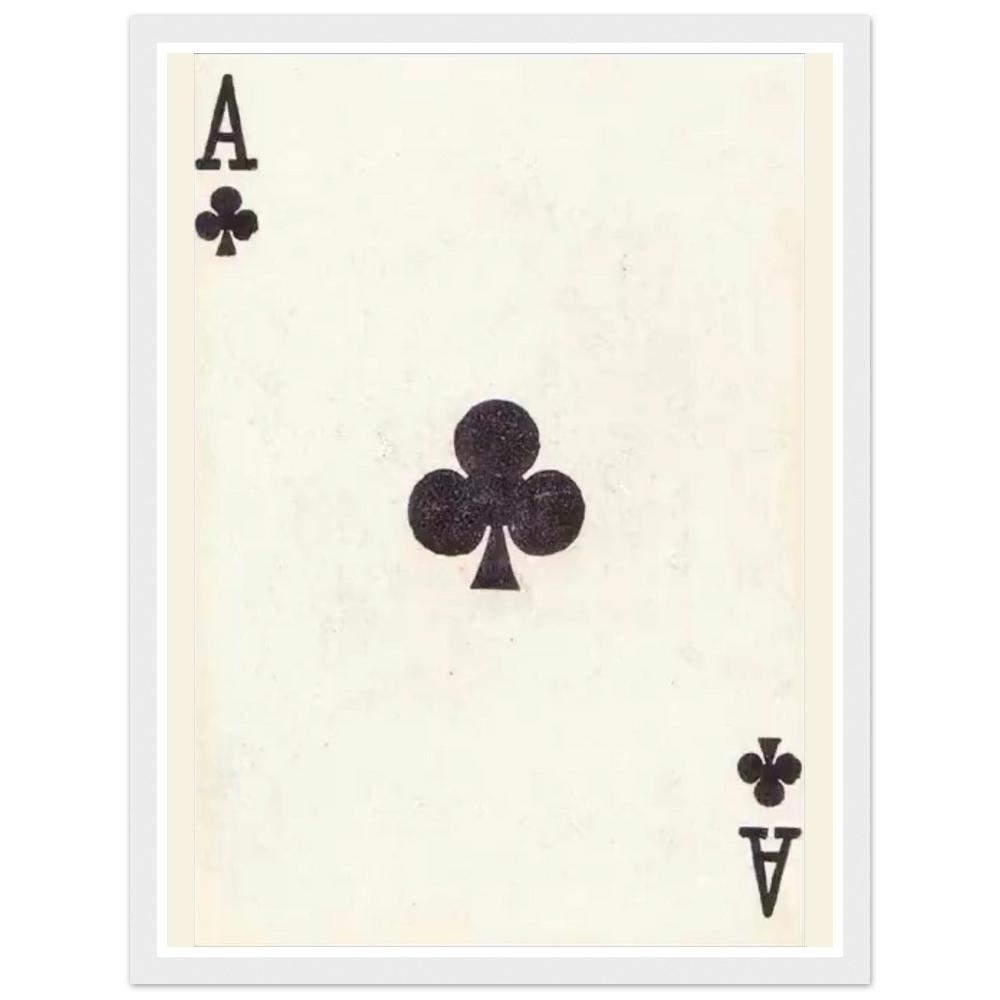 Black ace of clubs playing card on an aged cream background in a white frame.