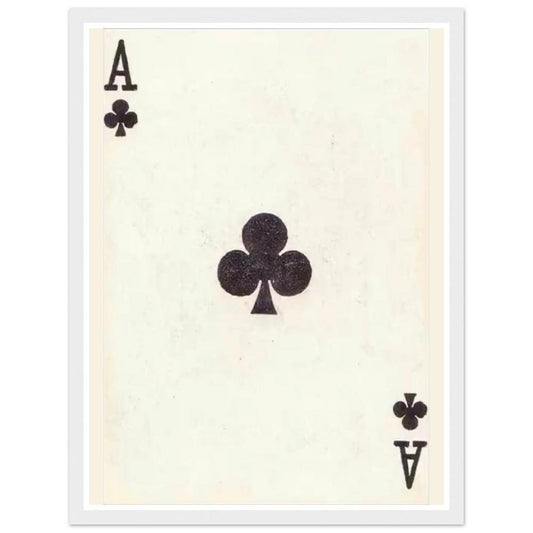 Black ace of clubs playing card on an aged cream background in a white frame.