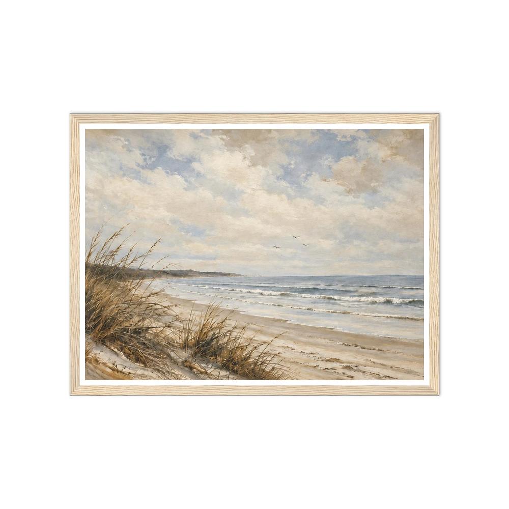 Beach grasses on sandy dunes beside gentle waves under a cloudy blue sky in a natural wood frame.