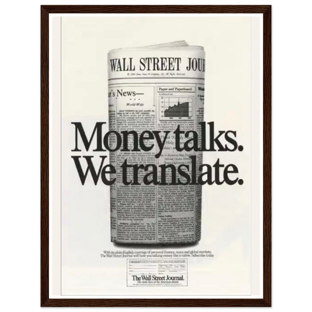 Money talks. We translate. lettering over a rolled financial newspaper in a dark wood frame.