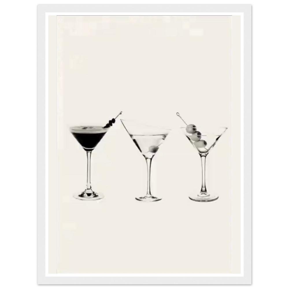 Three martini glasses with cocktail garnishes on a cream background in a white frame.
