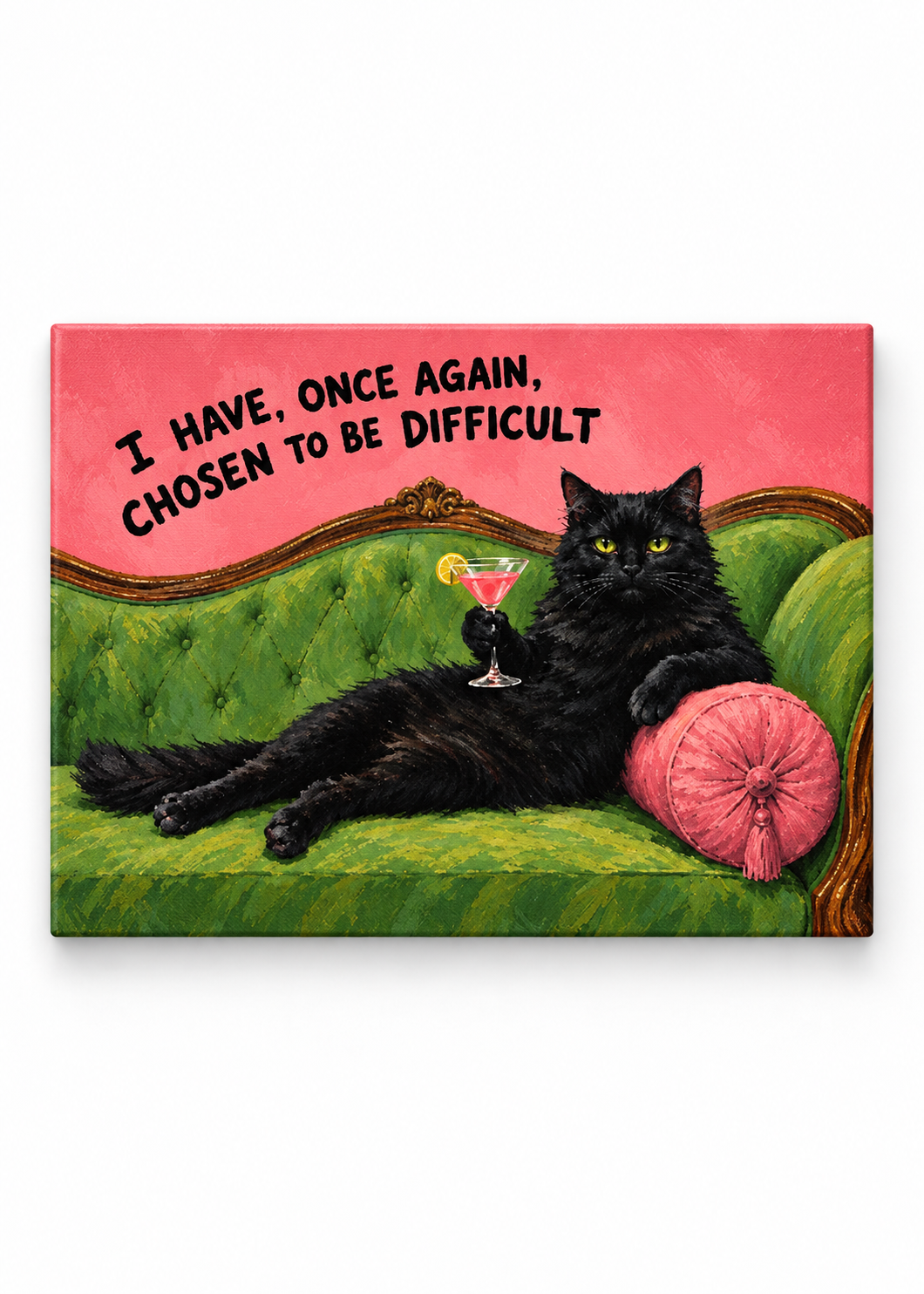 Black cat with a cocktail on a green sofa beneath a chosen to be difficult quote as a canvas print.