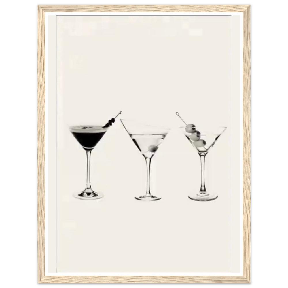 Three martini glasses with cocktail garnishes on a cream background in a natural wood frame.